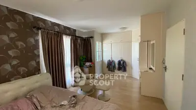 Spacious bedroom with elegant decor and ample natural light