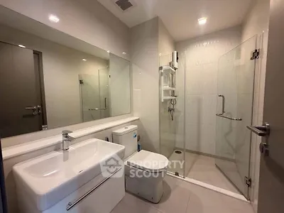 Modern bathroom with sleek fixtures and glass shower enclosure