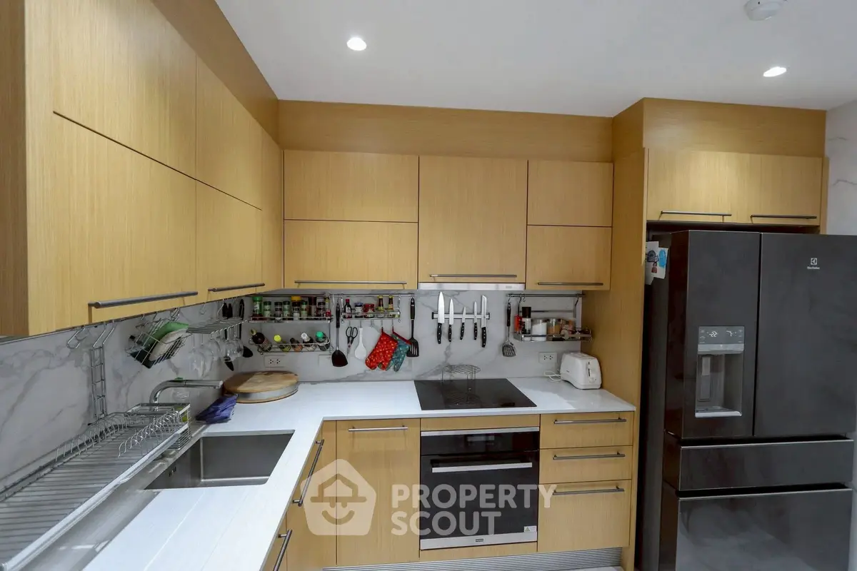 Modern kitchen with sleek wooden cabinets and stainless steel appliances