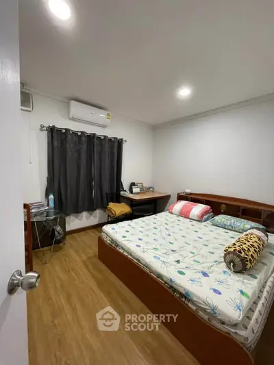Cozy bedroom with wooden flooring and modern decor