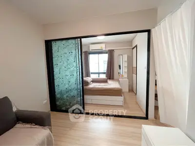 Modern bedroom with sliding glass doors and cozy decor in a stylish apartment.