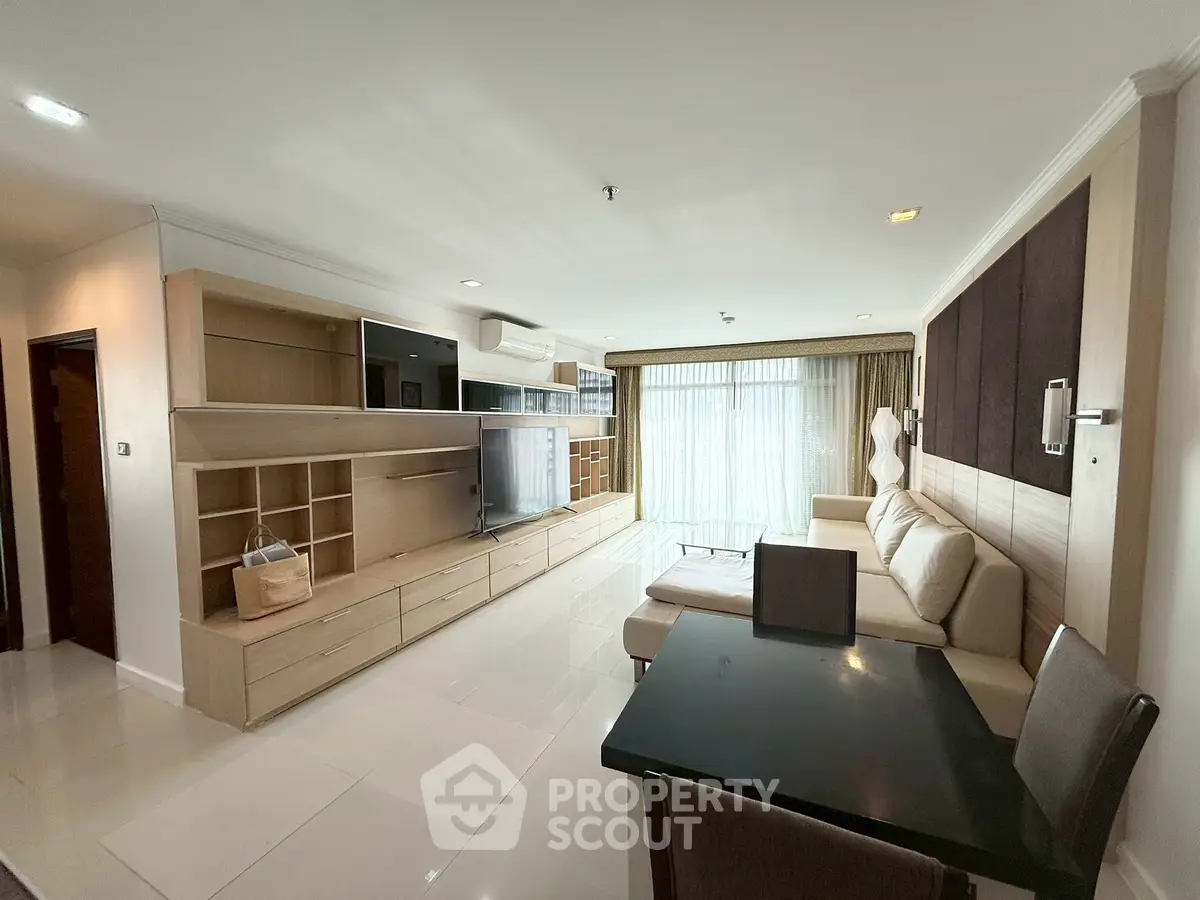 Spacious modern living room with sleek furniture and large windows for natural light.