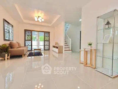 Spacious modern living room with elegant decor and large windows.