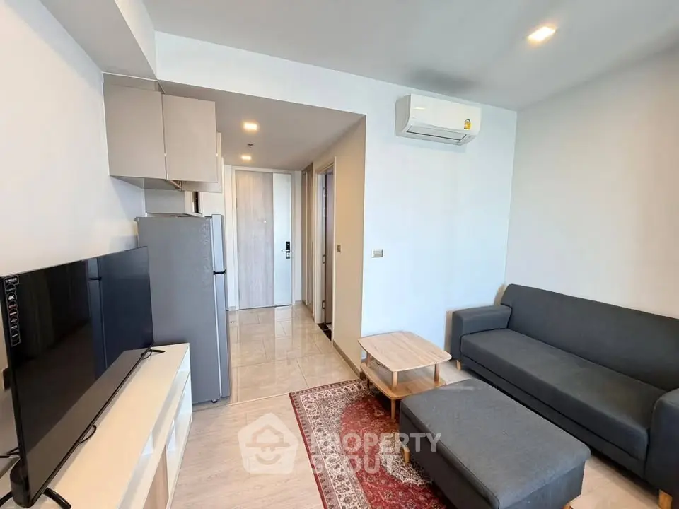 Modern living room with sleek furniture and air conditioning in a stylish apartment.