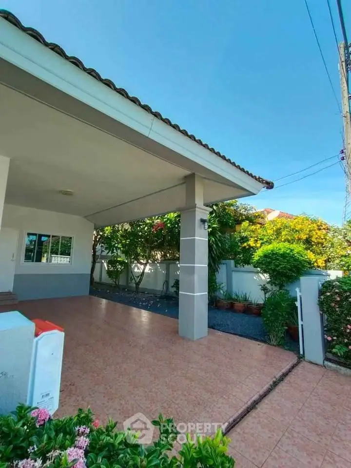 Charming suburban home with spacious driveway and lush garden, perfect for family living.