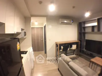 Modern living room with sleek furniture and built-in air conditioning in a cozy apartment.