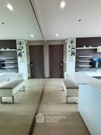 Modern living room with mirrored wall and sleek furniture design