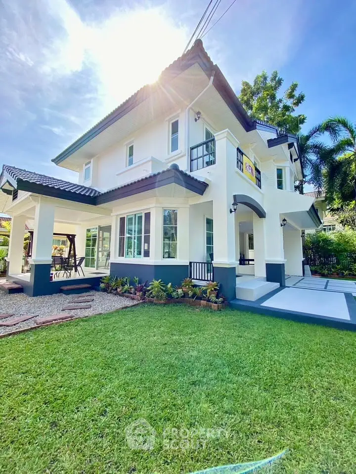 Stunning two-story house with lush garden and modern architecture in a serene neighborhood.