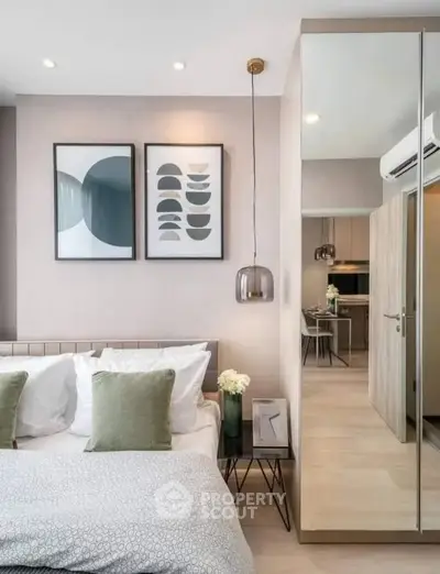 Modern bedroom with stylish decor and mirrored wardrobe