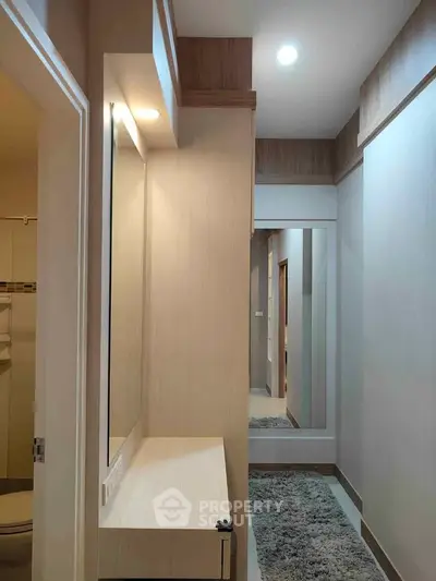Modern hallway with elegant lighting and large mirror in contemporary home
