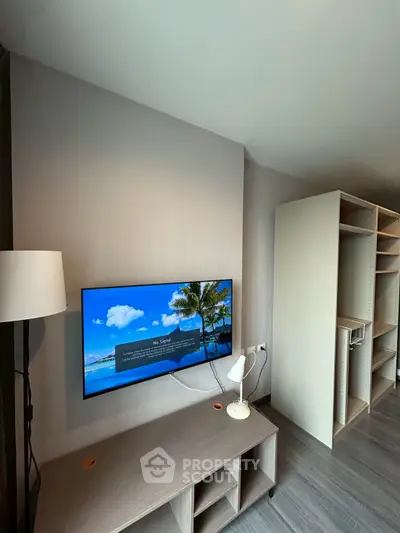 Modern living room with wall-mounted TV and sleek storage unit