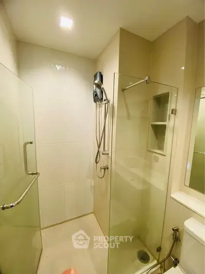 Modern bathroom with glass shower enclosure and sleek fixtures