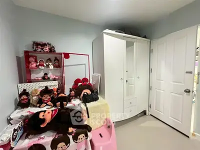 Charming bedroom with playful decor and ample storage space