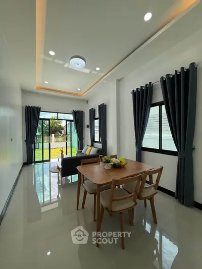 Modern living room with elegant dining area and garden view