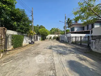 Charming residential street with modern houses and lush greenery, perfect for serene living.