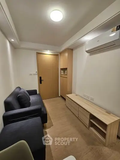 Modern living room with sleek furniture and air conditioning in a cozy apartment.