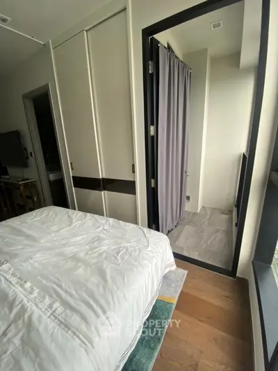 Modern bedroom with balcony access and sleek design