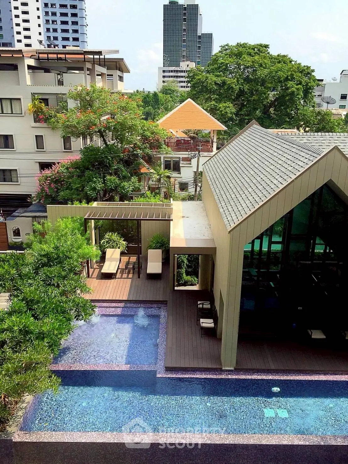 Luxurious urban poolside view with modern architecture and lush greenery