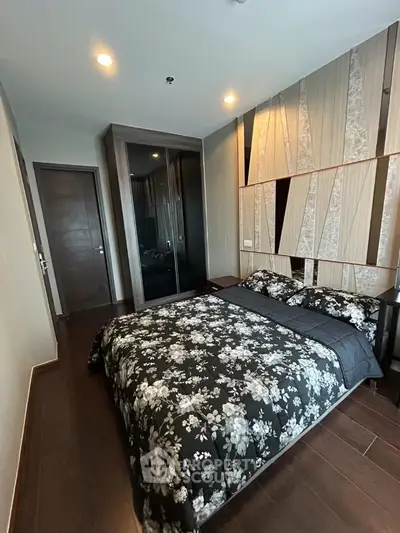 Modern bedroom with stylish decor and dark wood flooring