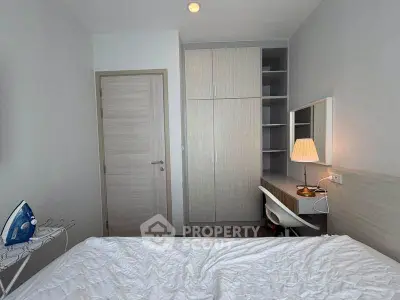 Cozy bedroom with modern wardrobe and study desk, perfect for comfortable living.