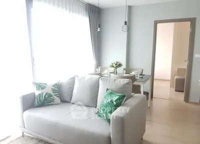 Bright and modern living room with stylish decor and dining area in open layout apartment.