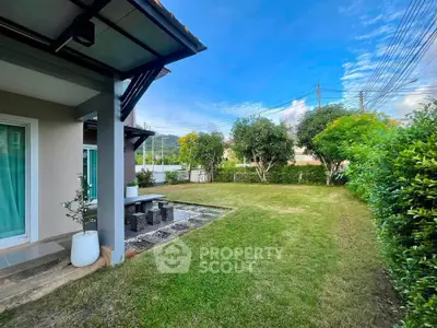 Spacious garden area with lush greenery and modern patio, perfect for outdoor relaxation.