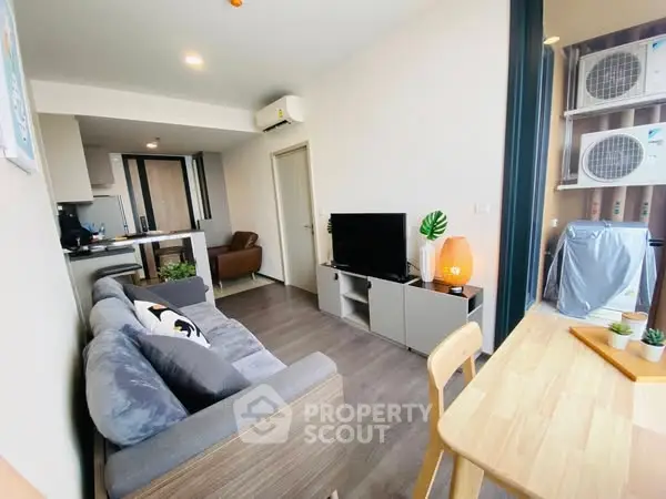 Modern living room with cozy sofa and dining area in stylish apartment