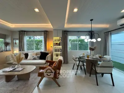 Modern living room with stylish furniture and dining area, featuring large windows and elegant lighting.