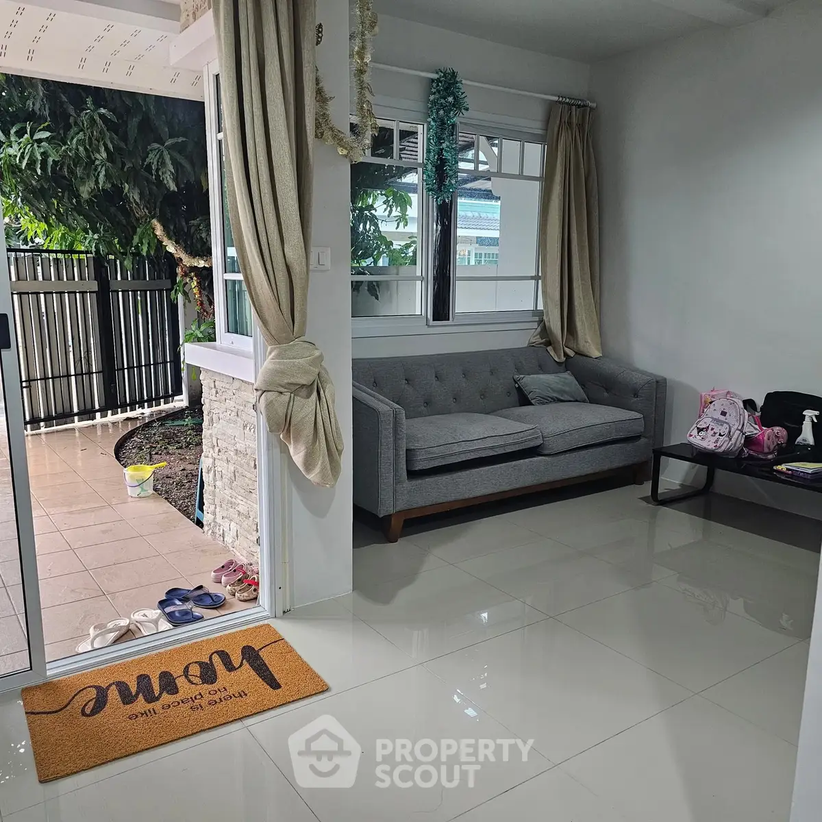 Cozy living room with modern sofa and garden view, perfect for relaxation.