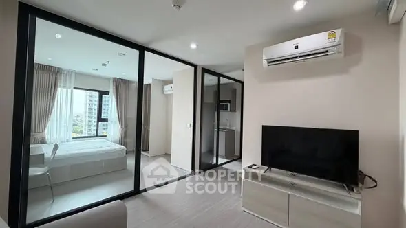 Modern apartment with glass partitions and sleek furnishings