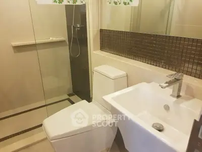 Modern bathroom with sleek fixtures and glass shower enclosure