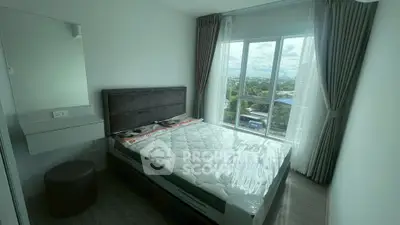 Bright bedroom with large window and scenic view in modern apartment