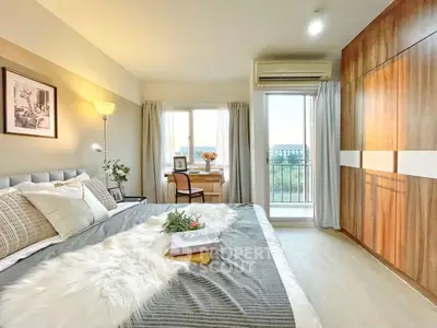 Spacious bedroom with modern decor and balcony view