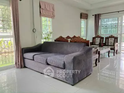 Spacious living room with elegant furniture and large windows for natural light.