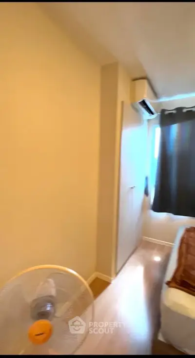 Cozy bedroom with air conditioning and natural light, perfect for relaxation.