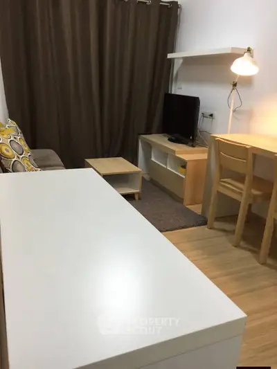 Cozy living room with modern furniture and warm lighting, perfect for relaxation and entertainment.