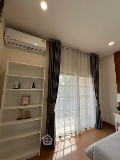 Cozy bedroom with elegant curtains and air conditioning, perfect for relaxation.