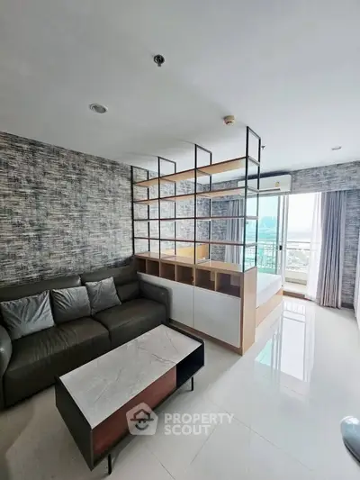 Modern living room with stylish partition and city view, featuring sleek furniture and natural light.
