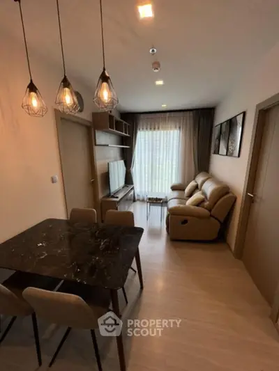 Modern living room with stylish lighting and cozy seating area.