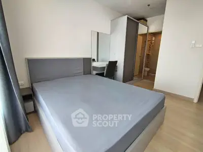 Modern bedroom with sleek design and ensuite bathroom in a stylish apartment.