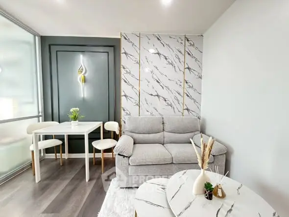 Modern living room with stylish marble accents and cozy seating area.