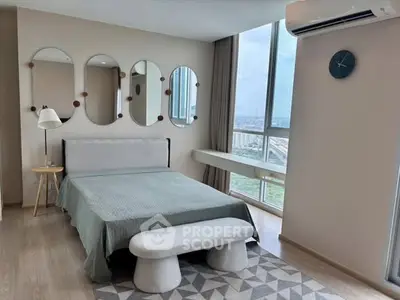 Modern bedroom with large windows and stylish decor in a high-rise apartment.