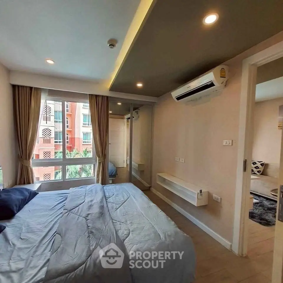 Modern bedroom with large window and air conditioning in stylish apartment