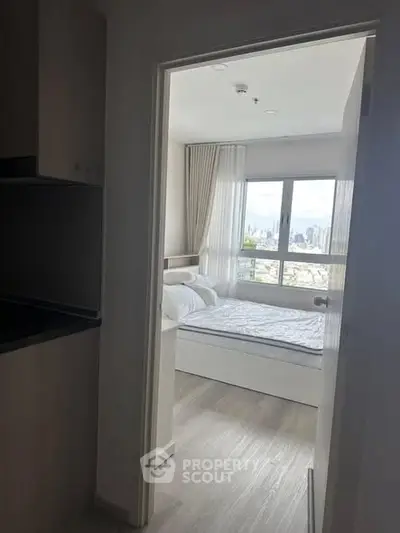 Bright bedroom with city view and modern decor