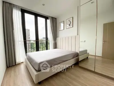 Modern bedroom with large window and stylish decor in urban apartment