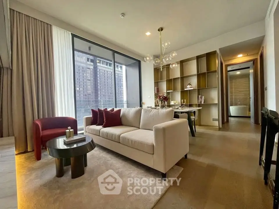 Luxurious living room with modern decor and city view, featuring elegant furniture and ambient lighting.