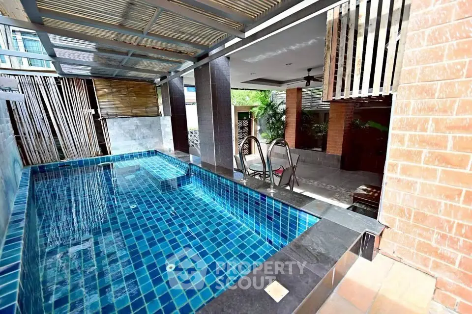 Luxurious private pool area with modern design and shaded seating
