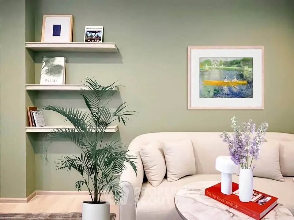 Stylish living room with modern decor, featuring a cozy sofa, elegant shelves, and vibrant artwork on a green wall.