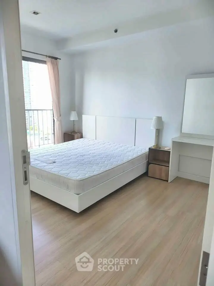 Bright and airy bedroom with large window and minimalist decor