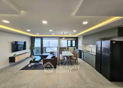Spacious modern living room with open kitchen and stunning city view.